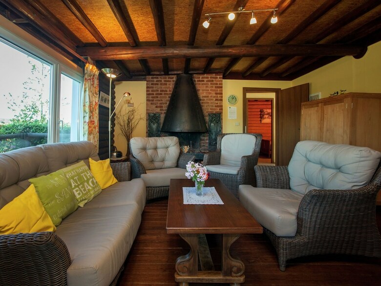 Open Wooden Chalet Built Against A Hill