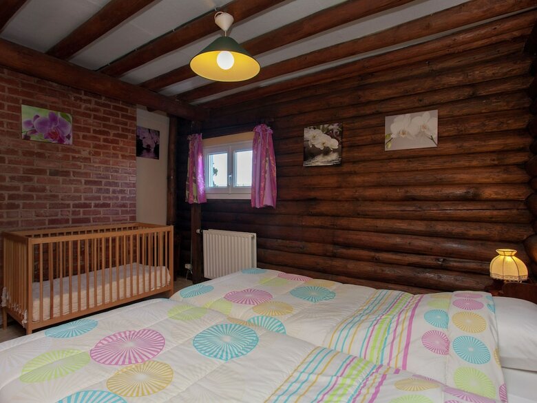 Open Wooden Chalet Built Against A Hill