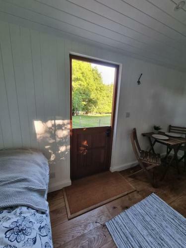 Shepherds Hut Surrounded By Fields And The Jurassic Coast